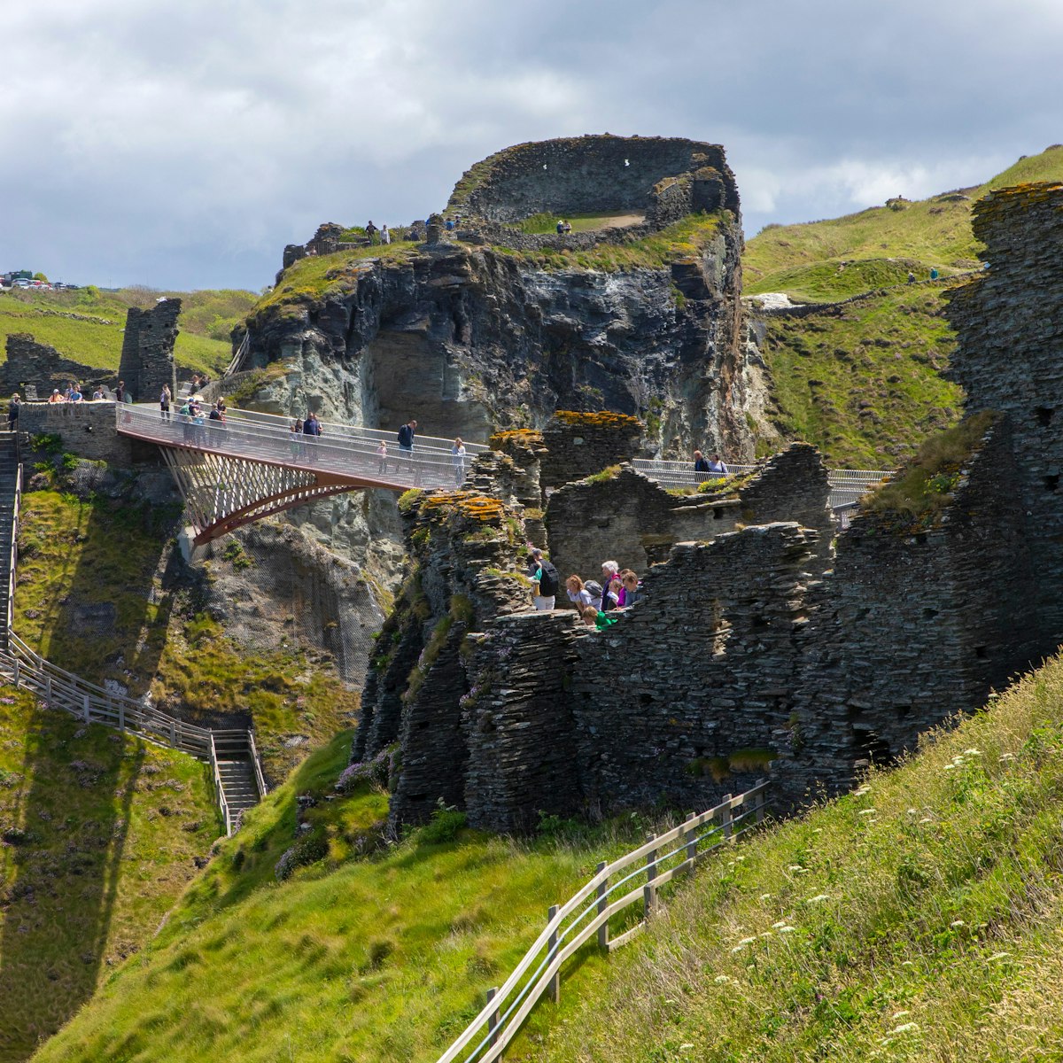A view of the footbridge and castle ruins at Tintagel Castle in Cornwall, UK.; Shutterstock ID 1988916434; your: Bridget Brown; gl: 65050; netsuite: Online Editorial; full: POI Image Update