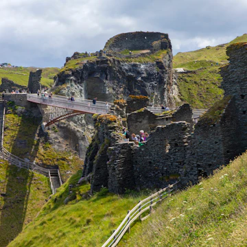 A view of the footbridge and castle ruins at Tintagel Castle in Cornwall, UK.; Shutterstock ID 1988916434; your: Bridget Brown; gl: 65050; netsuite: Online Editorial; full: POI Image Update