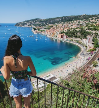 A young woman looking over the beach in Nice, France