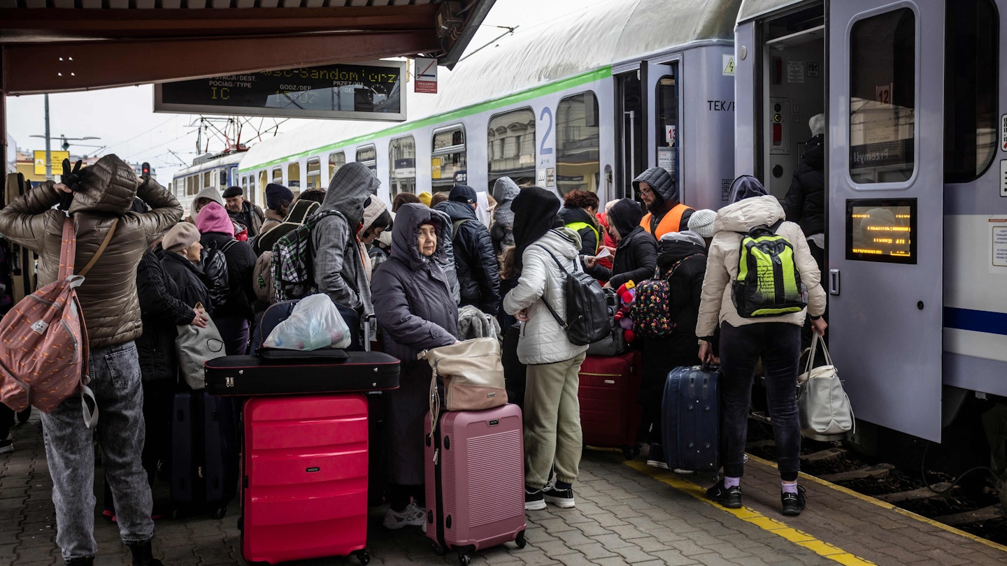 Refugees from Ukraine are seen on the platform boarding the train to Warsaw, at the railway station in Przemysl, southeastern Poland, on April 5, 2022. - More than 4.2 million Ukrainian refugees have fled the country since the Russian invasion, the UN says. (Photo by Wojtek RADWANSKI / AFP) (Photo by WOJTEK RADWANSKI/AFP via Getty Images)