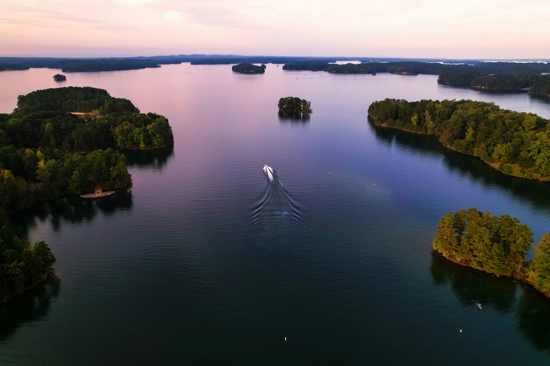 An aerial shot of a motorboat on Lake Lanier, Georgia, at dusk