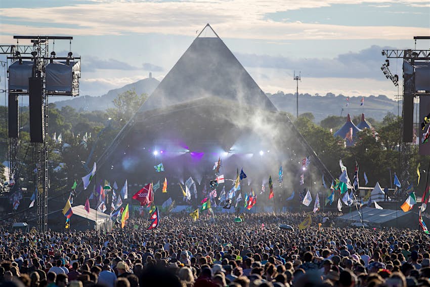 GLASTONBURY, ENGLAND - JUNE 25:  People gather in front of the Pyramid Stage  at Worthy Farm in Pilton on June 25, 2017 near Glastonbury, England. Glastonbury Festival of Contemporary Performing Arts is the largest greenfield festival in the world. It was started by Michael Eavis in 1970 when several hundred hippies paid just £1, and now attracts more than 175,000 people  (Photo by Matt Cardy/Getty Images)