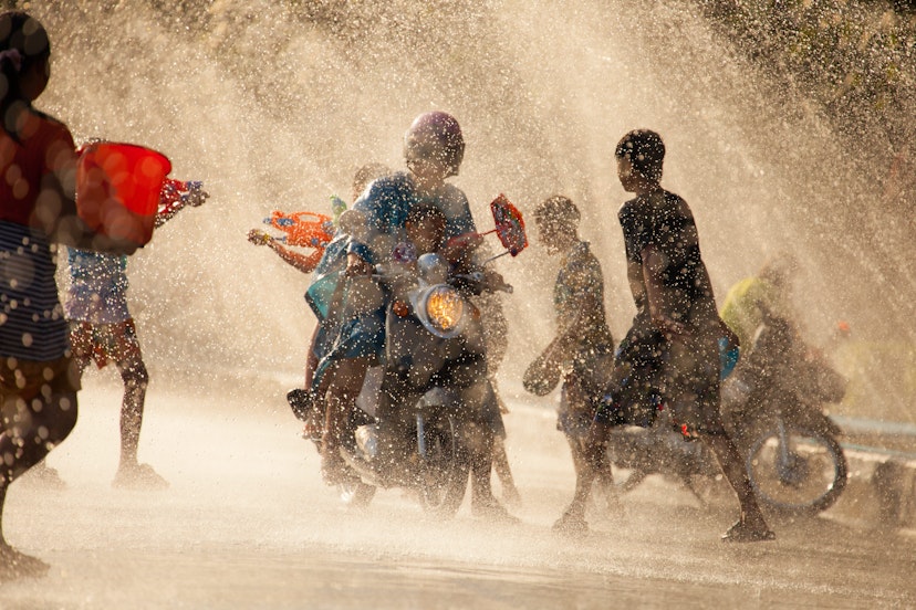 People shooting water guns and splashing water on each other in the city of Chanthaburi during Songkran Festival.