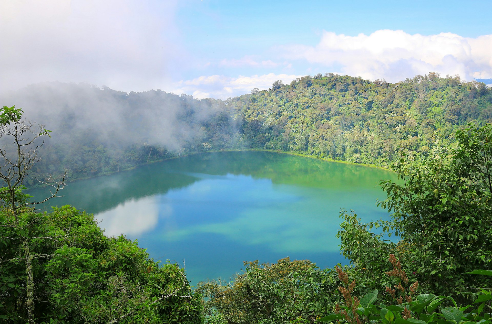 Mist swirls around the crater lake of Laguna Chicabal, Guatemala