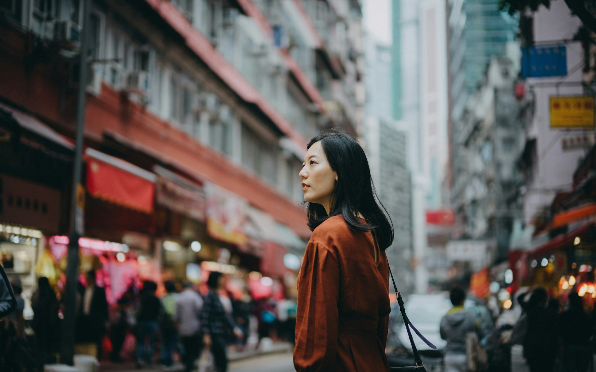 Young Asian woman exploring and strolling in local street market in Hong Kong