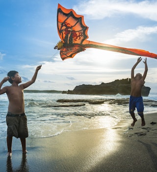 Kids playing with a kite at Tabanan village, Bali