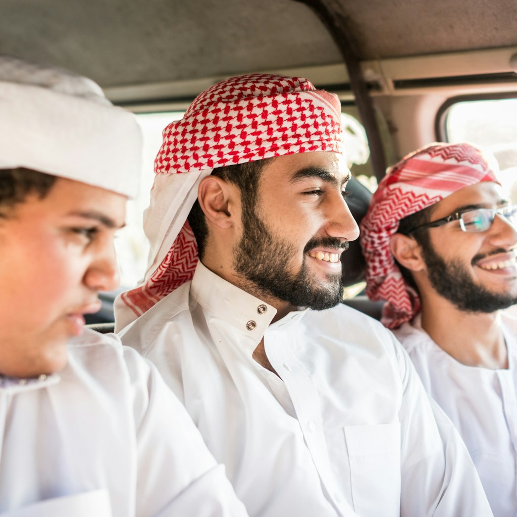 Young Arab friends enjoying car travel