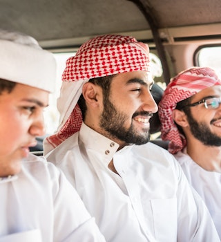 Young Arab friends enjoying car travel