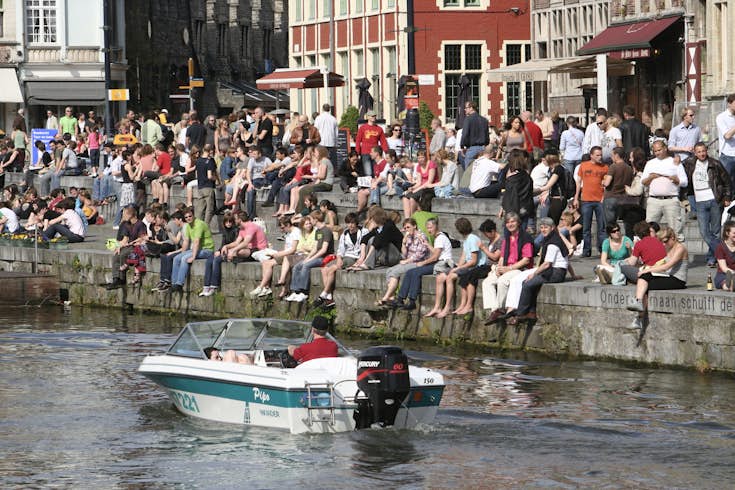 Students relaxing by River Leie in Ghent, Belgium 