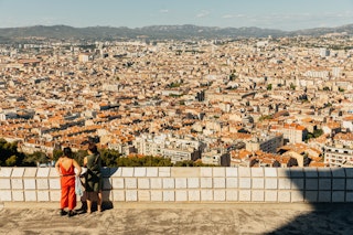 Two women looking over the city of Marseille.