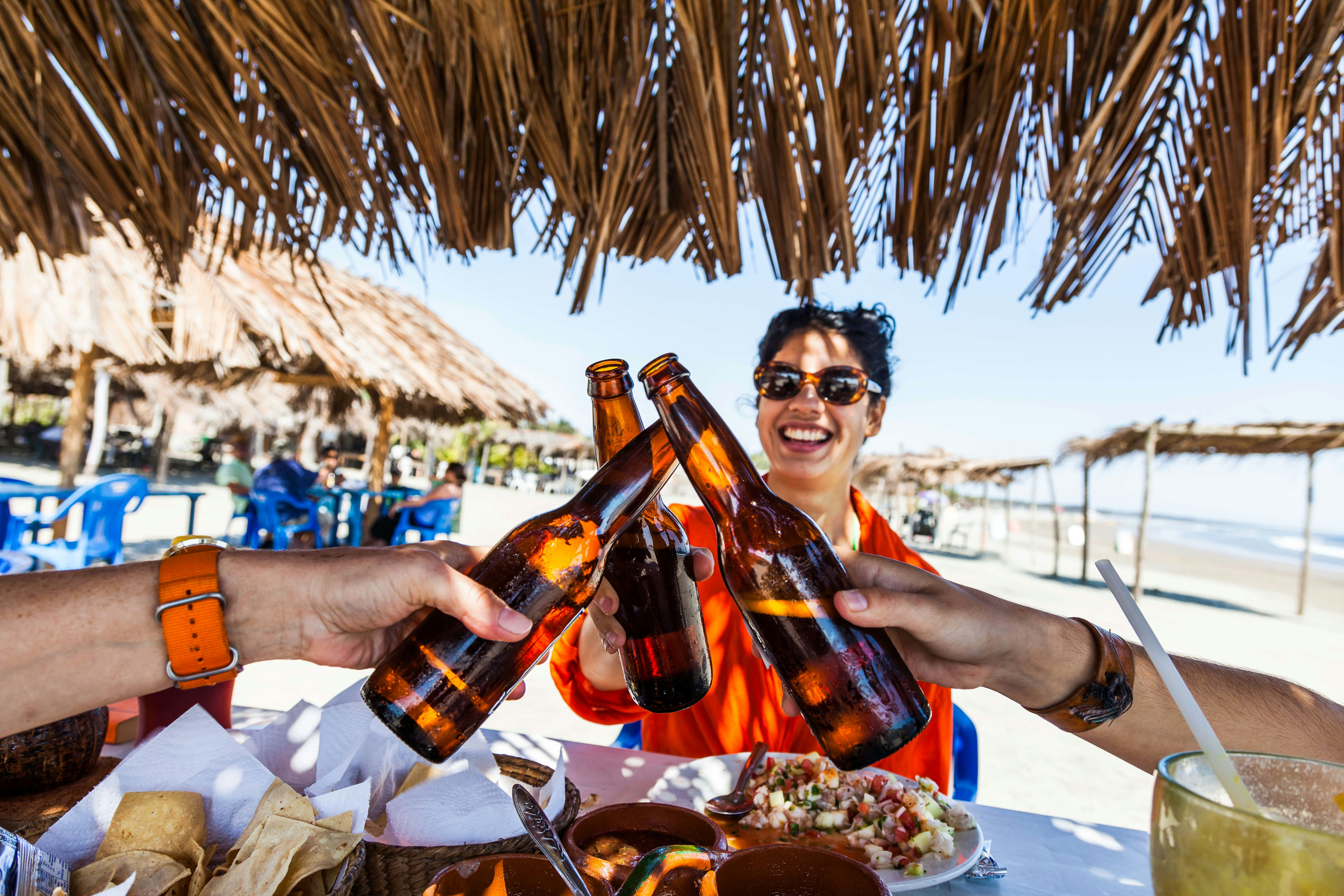 Having a meal under a beach palapa in Mexico - stock photo
A Spanish woman in her early twenties laughing as she toasts good health on a beach in Mexico.
