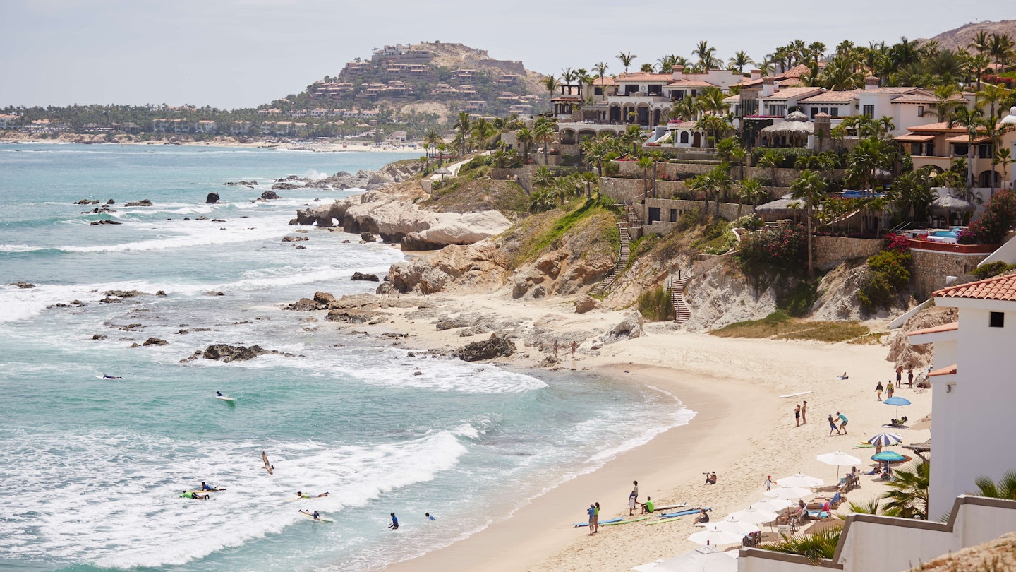 A view from the hilltop of the action on a beautiful sandy beach in Cabo San Lucas, Mexico