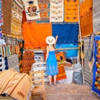 Woman admiring the handmade rugs in Oaxaca valley, Mexico