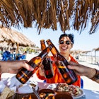 Having a meal under a beach palapa in Mexico - stock photo
A Spanish woman in her early twenties laughing as she toasts good health on a beach in Mexico.