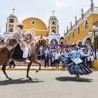 Marinera dancers perform in front of a church in Lima, Peru