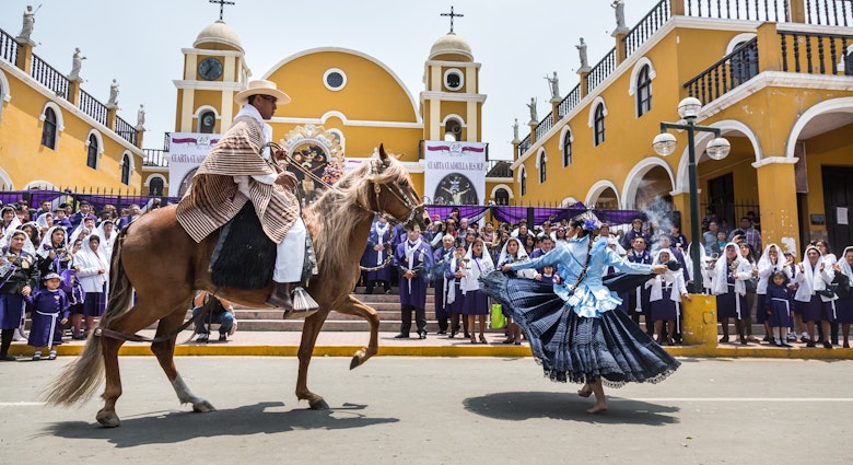 Marinera dancers perform in front of a church in Lima, Peru