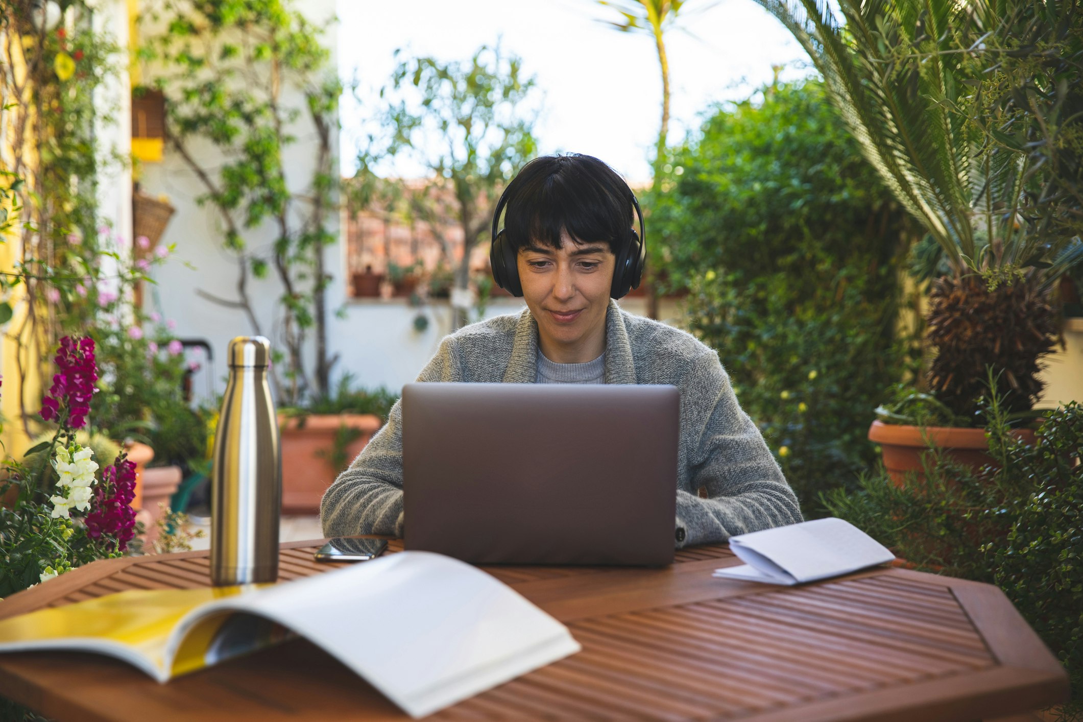 Woman at work from home patio in 