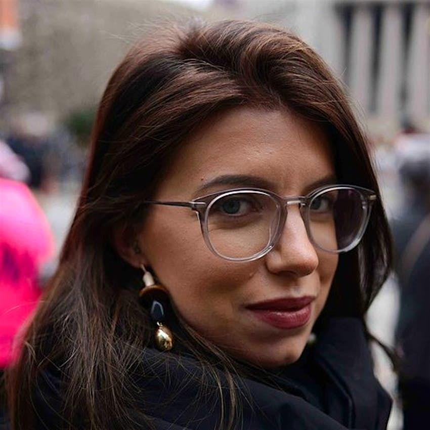 A close up portrait of Sasha Brady wearing glasses. 