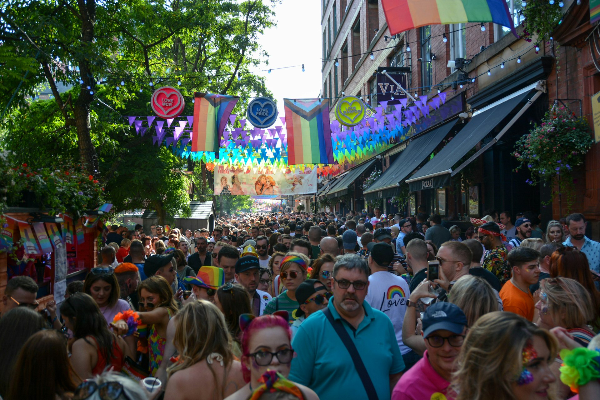 People celebrate during Manchester Pride, one of the UK's largest Gay Pride events including a parade and live music events throughout bank holiday weekend in August.
