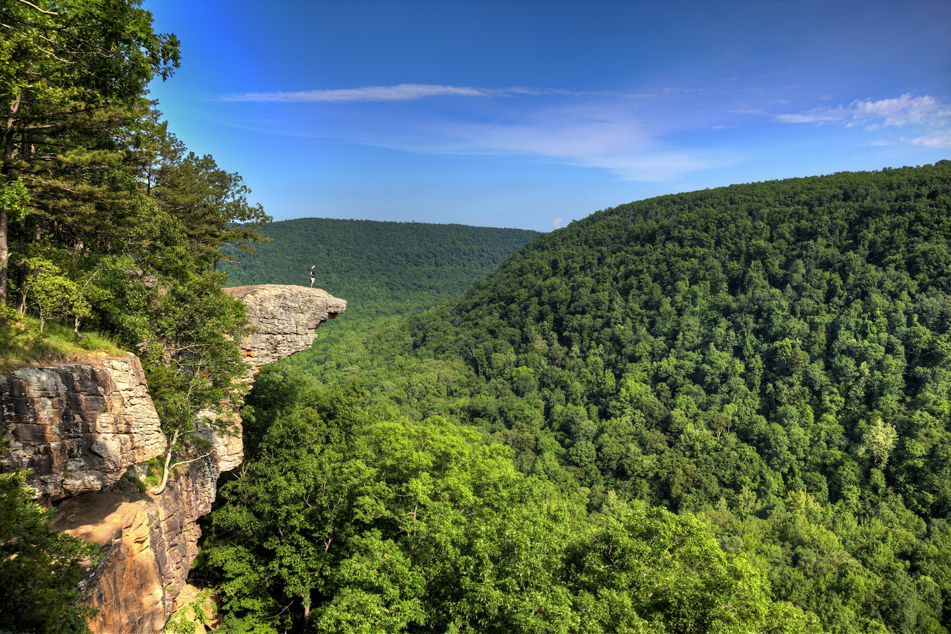 A person standing on the famed rocky outcrop on Whitaker's Point trail in the Ozarks, Arkansas