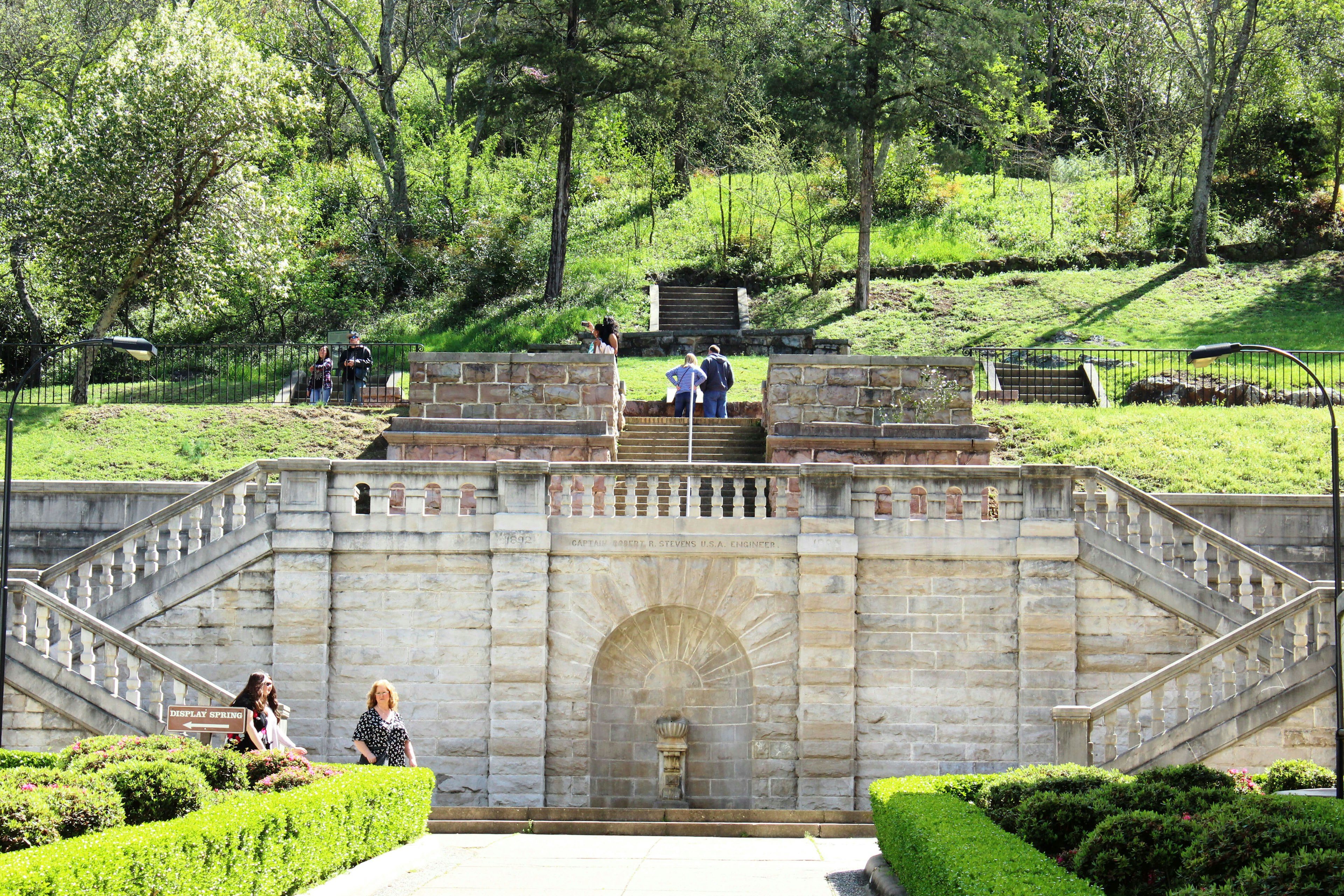 Tourists visit the formal entrance and balustrade to Hot Springs National Park, constructed in 1892, overseen by Captain Robert R Stevens, a West Point graduate