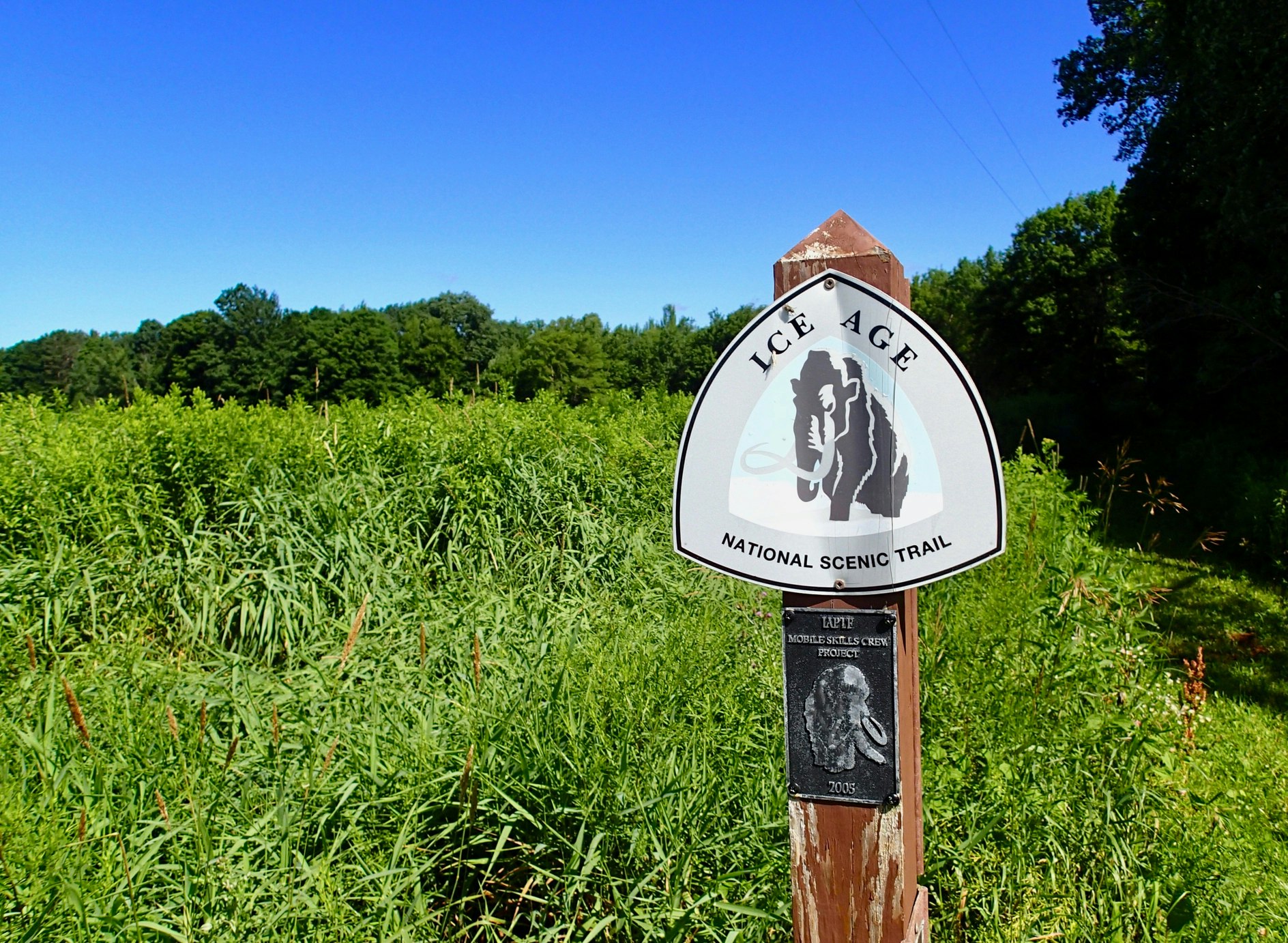 A sign saying "Ice Age National Scenic Trail" marks the hiking route across Wisconsin