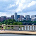 A runner crosses the Arlington Memorial Bridge over the Potomac River. - stock photo