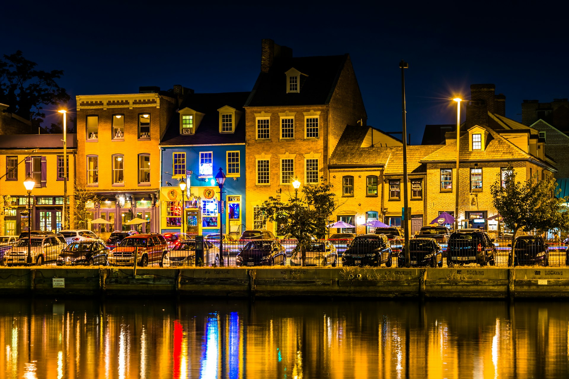 Shops and restaurants along the harbor at night in Fells Point, Baltimore, Maryland, USA