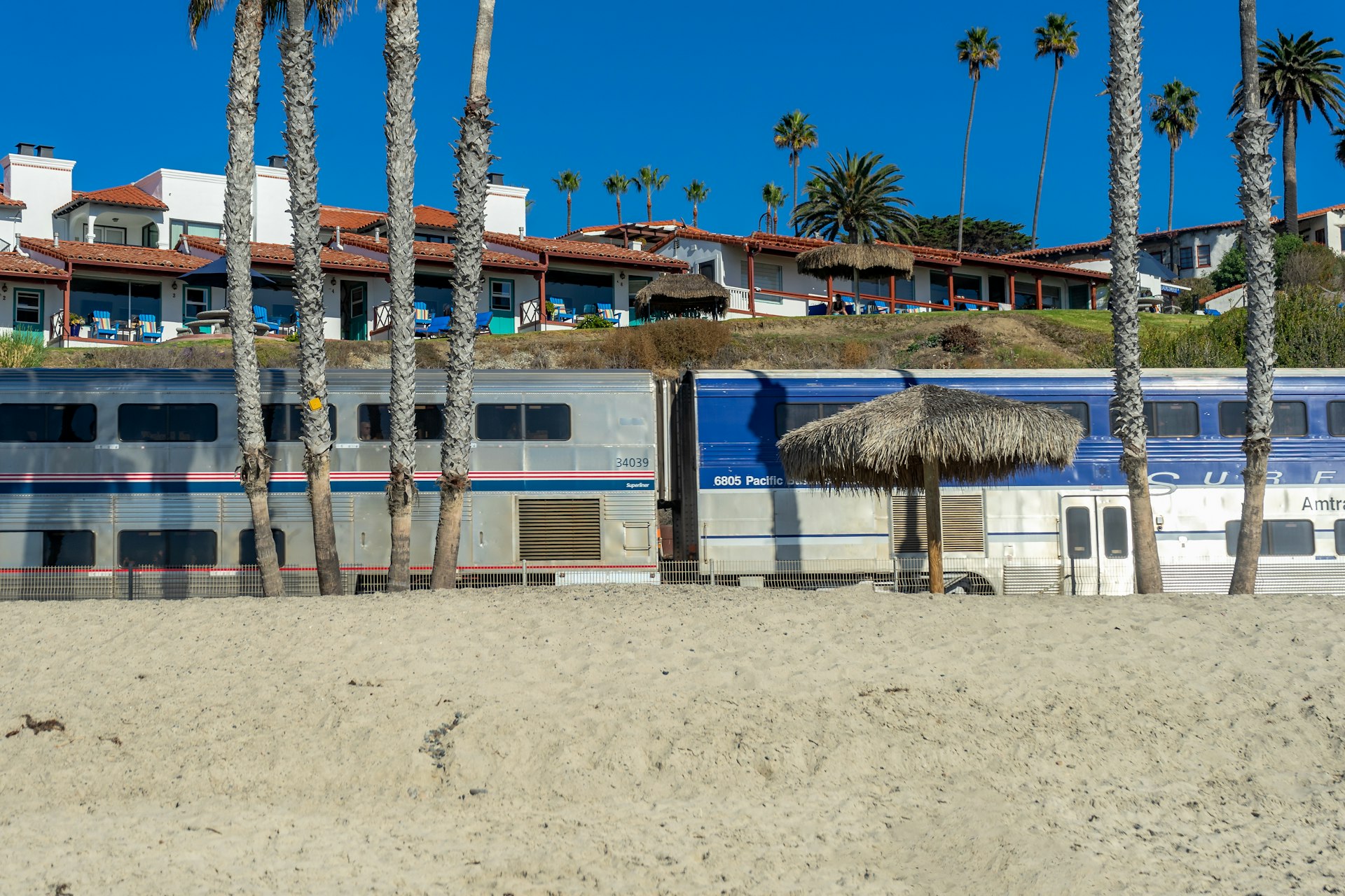 An Amtrak Pacific Surfliner train passing through the beach area in San Clemente, California, USA