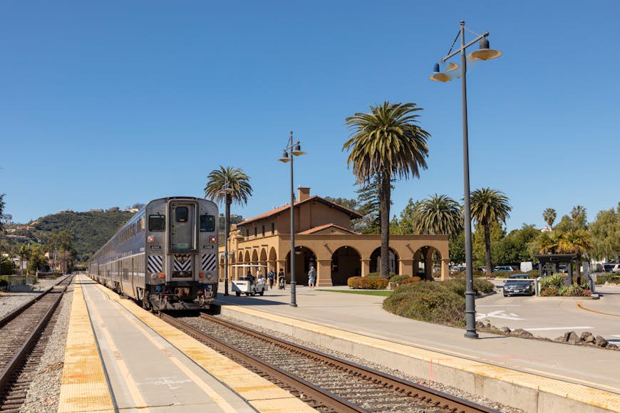 An Amtrak Surfliner train pulls into the mission-style train station in Santa Barbara, California, USA