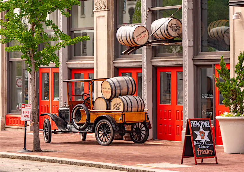 USA-Kentucky-4kclips-shutterstock_1450088615-RFE.jpg Exterior of the Frazier History Museum in Louisville, KY which includes old barrels of bourbon stacked up atop a 1920s-style open-back truck