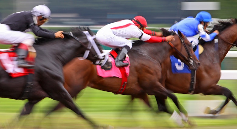 Riders push for the finish line in the Kentucky Derby, Louisville