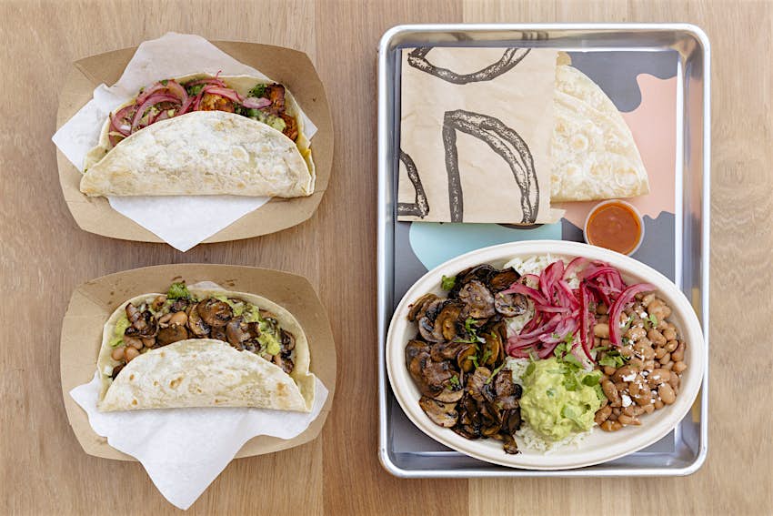 Overhead shot of two mushroom tacos and a mushroom plate from Loqui