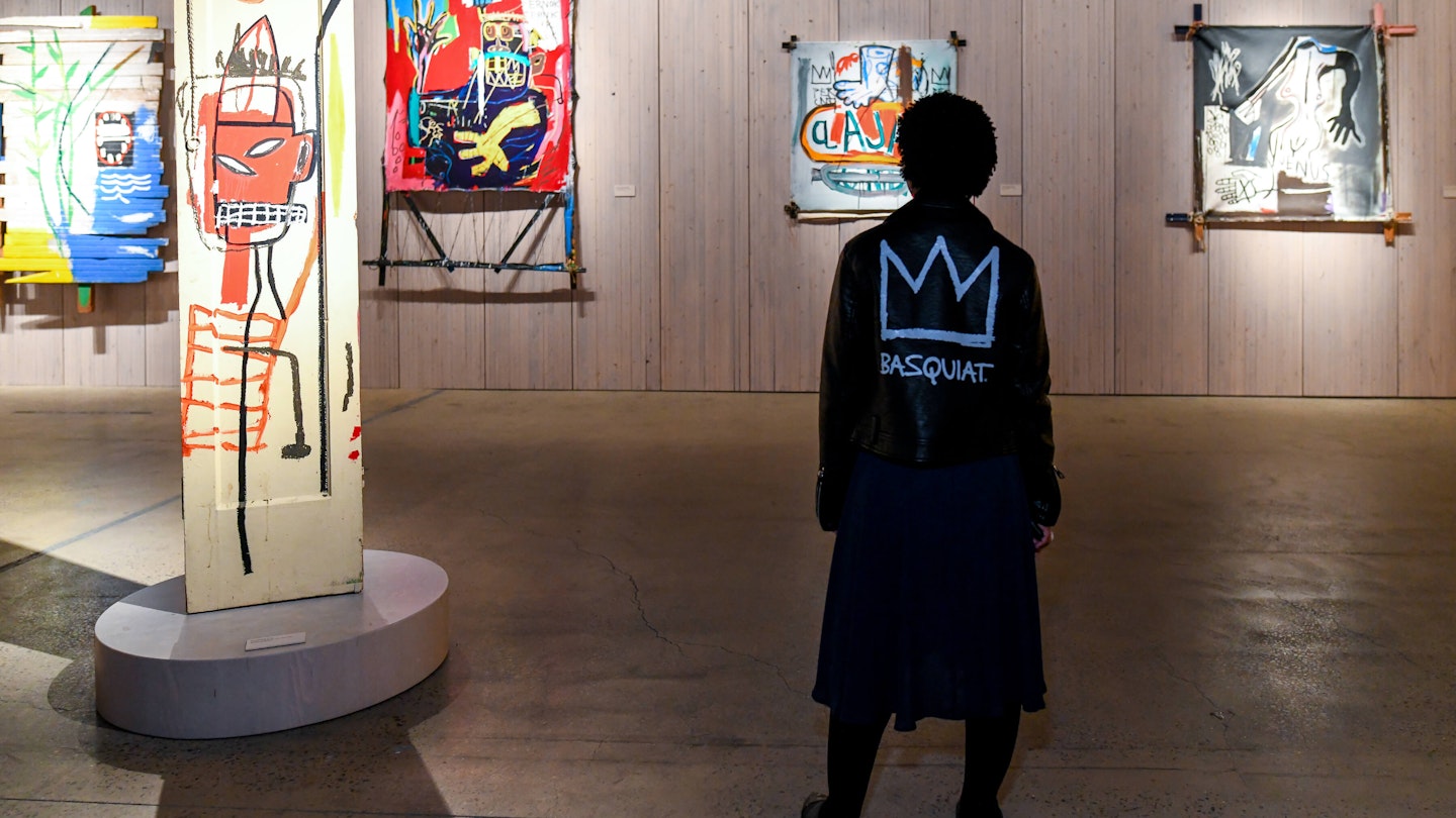 A guest taking in the exhibition at the Jean-Michel Basquiat King Pleasure© Opening Party with BOMBAY SAPPHIRE ® in NYC