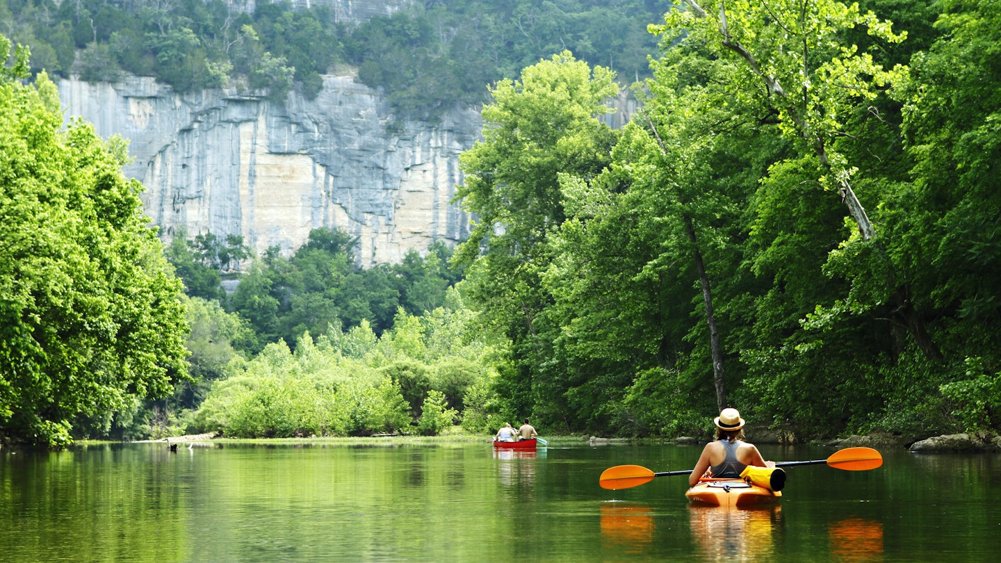 Kayaker and canoeist on the Buffalo National River in Arkansas from Steel Creek Campground.