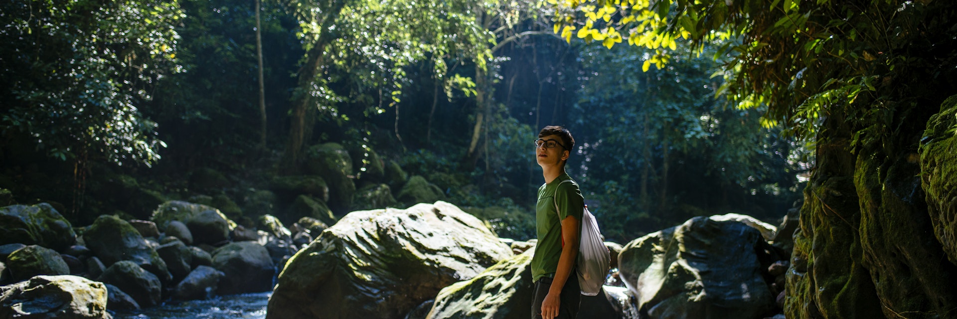 Young traveller is walking along a jungle stream in the amazon forest / Tarapoto/ north peru/ South America