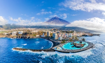 Aerial view with Puerto de la Cruz, in background Teide volcano, Tenerife island, Spain