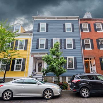 Boston, MA, USA - August 5, 2021: View of multi colored houses in Charlestown, Boston. Charlestown is the oldest neighborhood in Boston. Charlestown has many places of historical interest, some of which are included along the northern end of Boston's Freedom Trail.