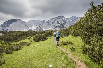 Two hikers in Sutjeska National Park, heading to the Maglic Massif, Bosnia and Herzegovina
