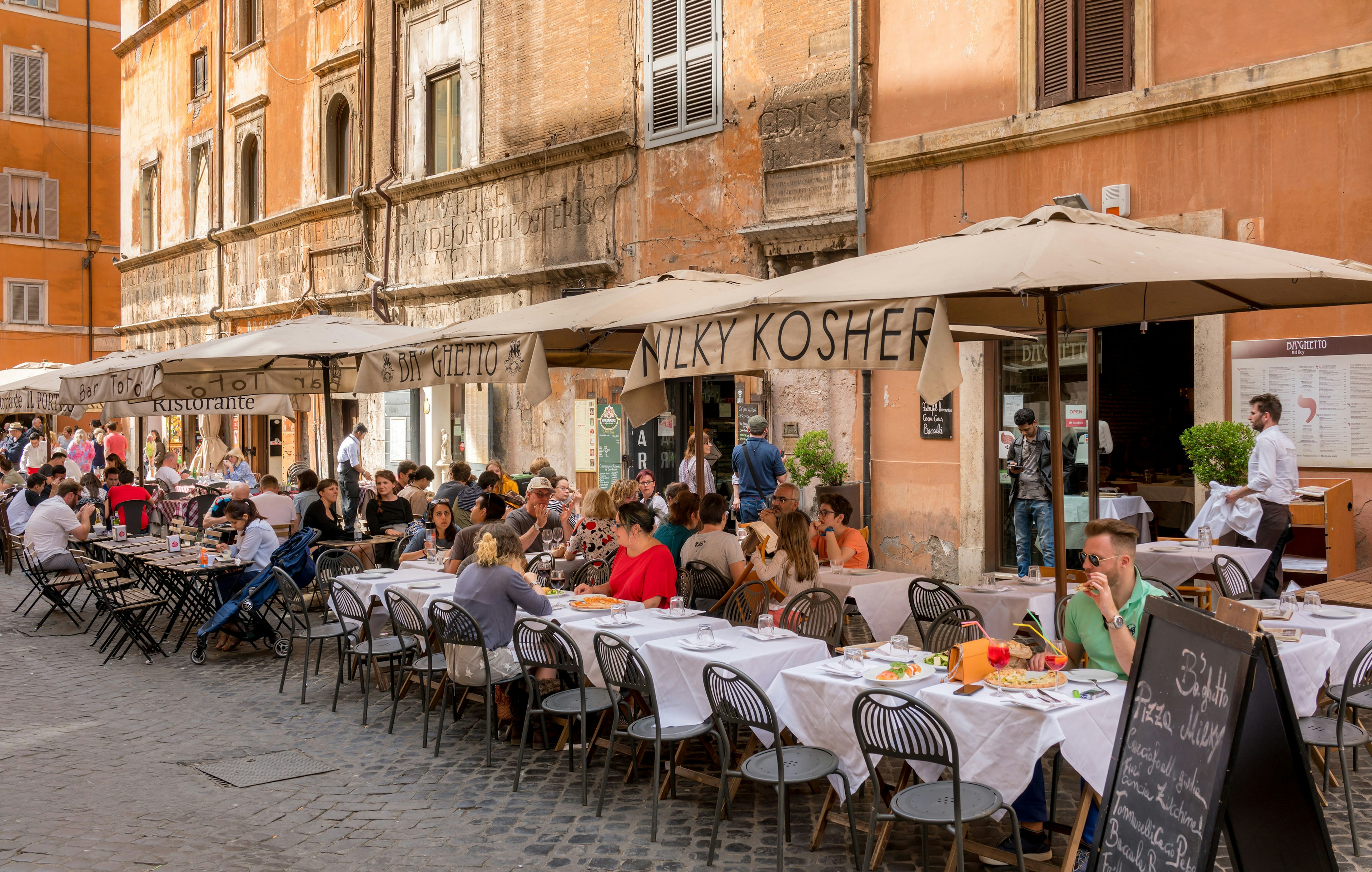 Diners outside a restaurant in the Jewish Ghetto quarter of Rome