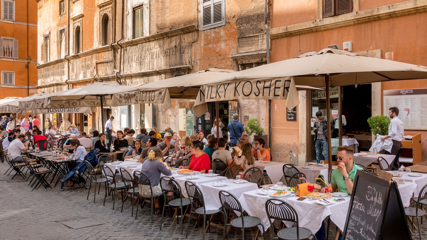 APRIL 30, 2018: Diners outside a restaurant in the Jewish Ghetto quarter of Rome.