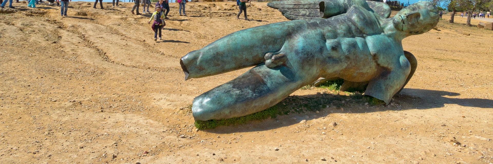 April 2, 2018: The Icarus statue, with tourists visiting the Temple of Concordia in the background.