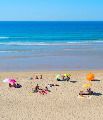 ODECEIXE, PORTUGAL - OCTOBER 04, 2018: People at  ocean beach in a summer sunny day. Odeceixe, Portugal