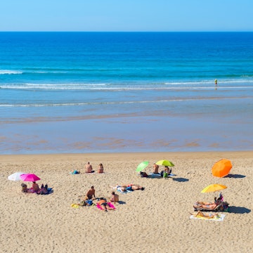 ODECEIXE, PORTUGAL - OCTOBER 04, 2018: People at  ocean beach in a summer sunny day. Odeceixe, Portugal