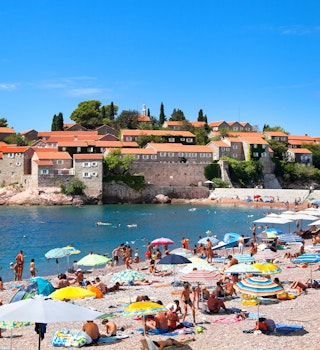 18 AUGUST, 2015: Visitors crowd Sveti Stefan Beach and Island area on a sunny summer day.