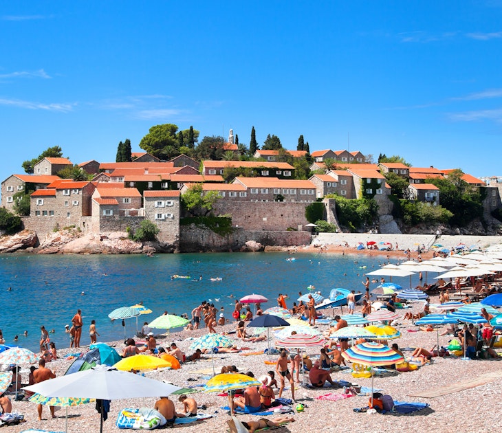 18 AUGUST, 2015: Visitors crowd Sveti Stefan Beach and Island area on a sunny summer day.