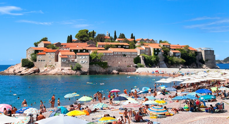 18 AUGUST, 2015: Visitors crowd Sveti Stefan Beach and Island area on a sunny summer day.