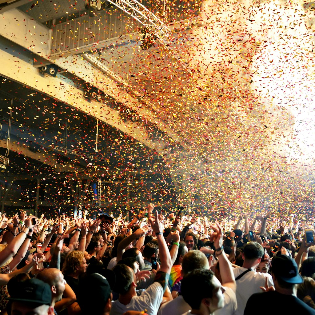 BARCELONA - JUN 19: Crowd in a concert, while throwing confetti from the stage at Sonar Festival on June 19, 2015 in Barcelona, Spain.
