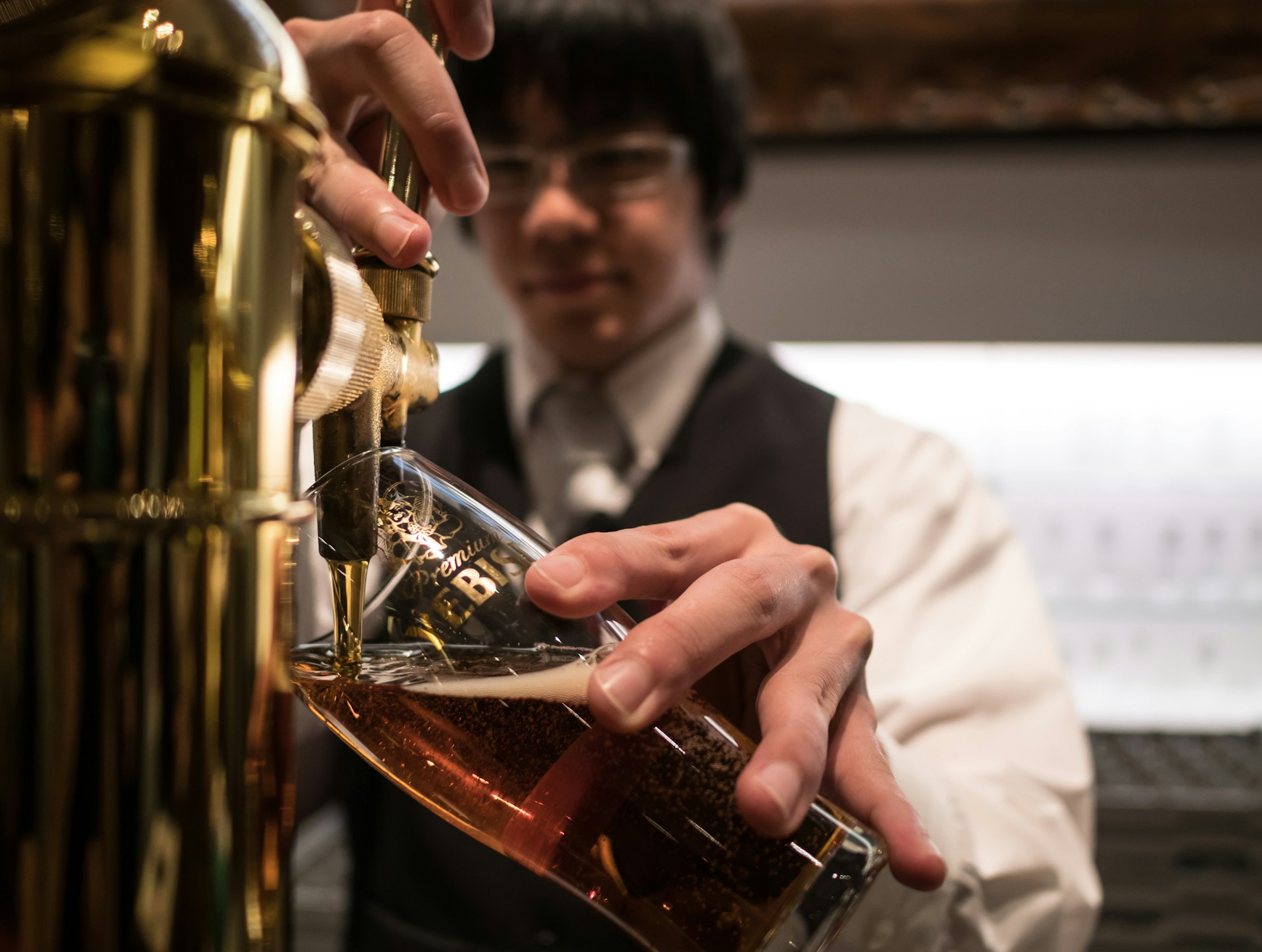 A bartender pours a beer at the Beer Museum Yebisu in Ebisu