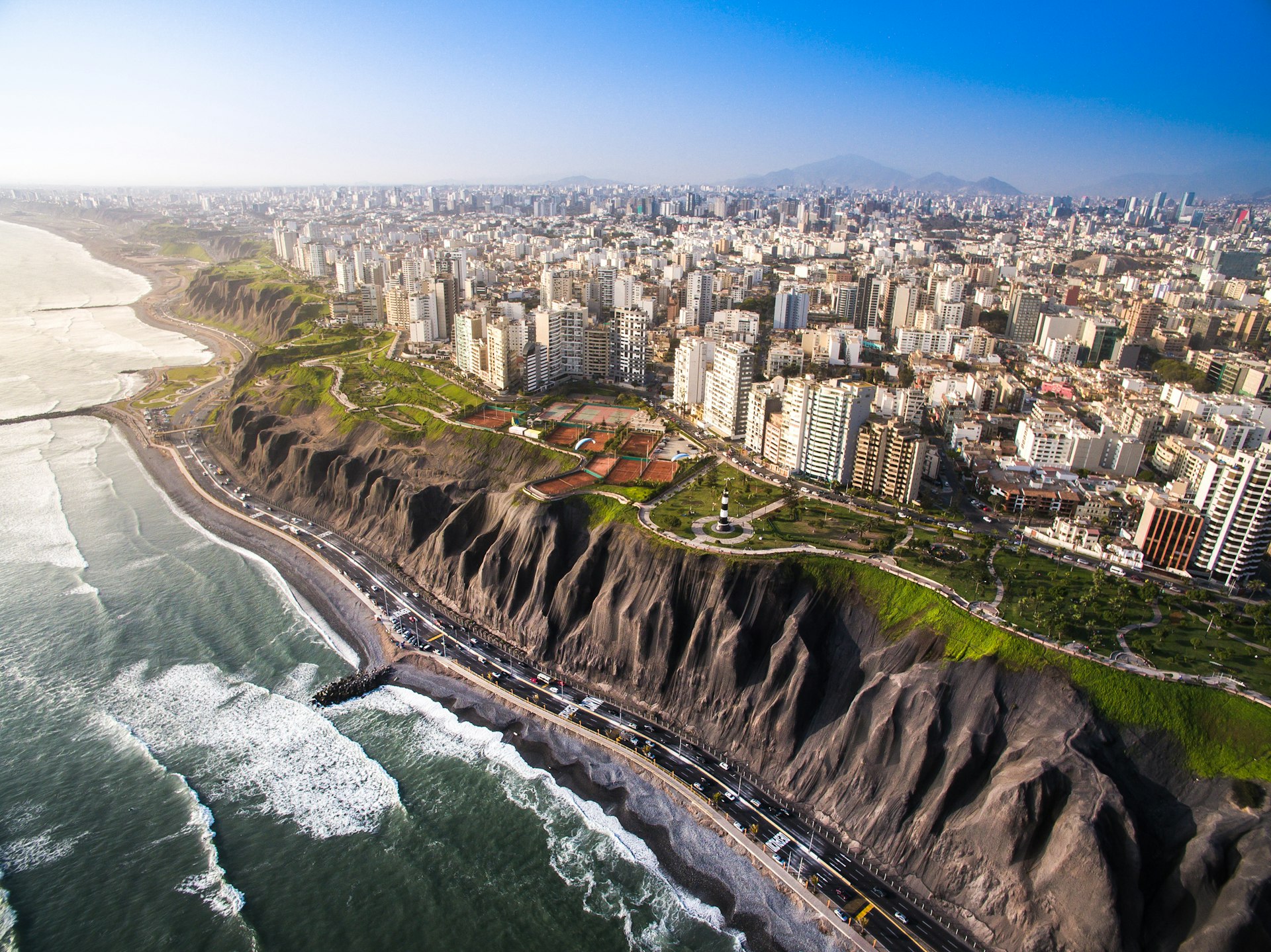 Panoramic view of Lima from Miraflores, with waves breaking on the beach